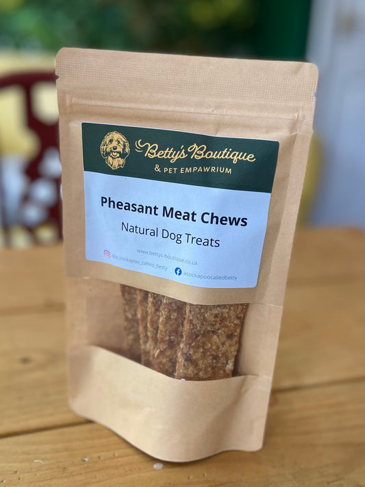Package of Pheasant Meat Chews for dogs with a visible brand label on a wooden surface.