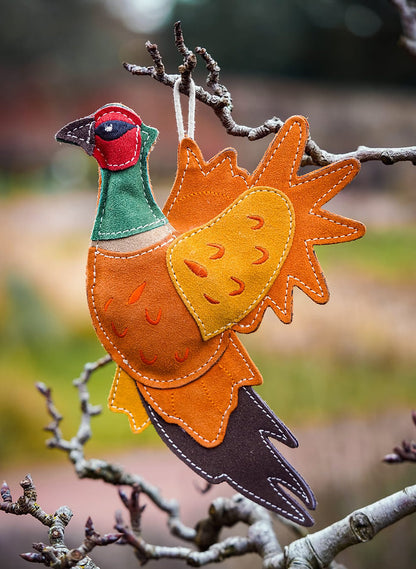 suede pheasant dog toy in tree