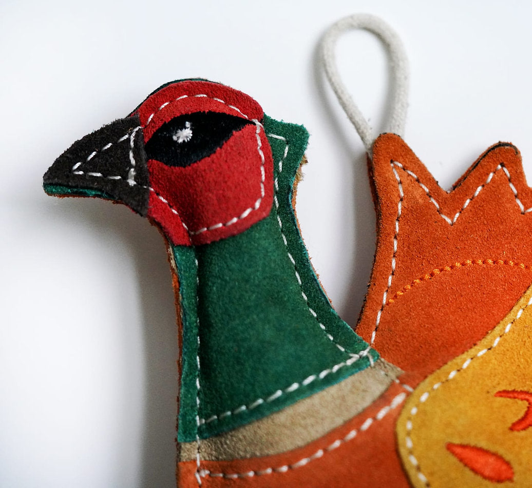 close up of suede pheasant dog toy