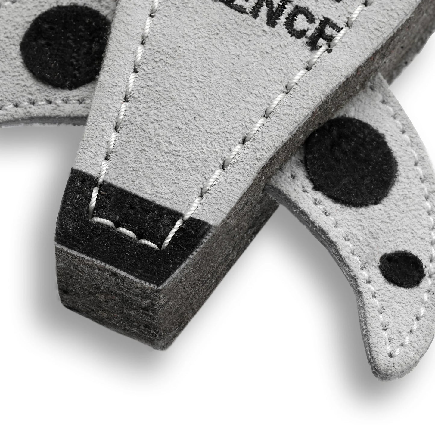 Close-up of a gray and black keychain with 'SILENCE' text on a white background