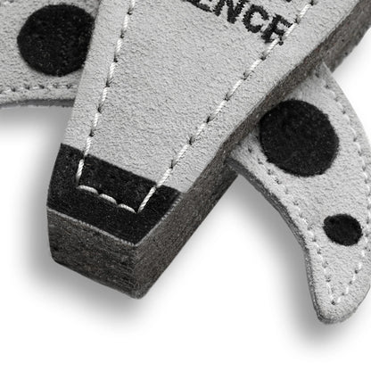 Close-up of a gray and black keychain with 'SILENCE' text on a white background