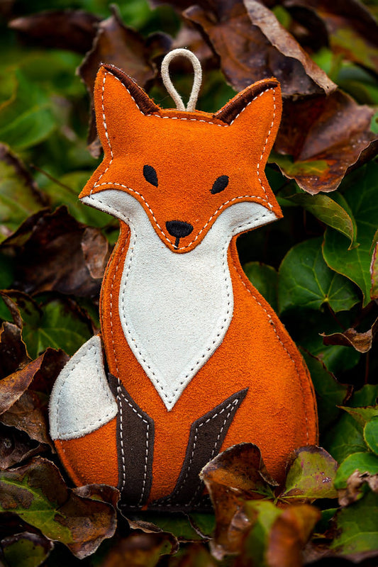 suede fox dog toy in leaves
