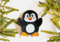 Poppy penguin dog toy in the snow